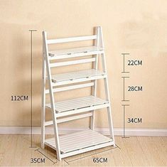 a white shelf with three shelves on each side and measurements for the height of it