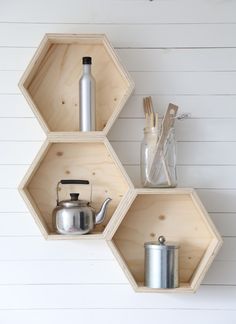 three wooden shelves with pots and pans on them