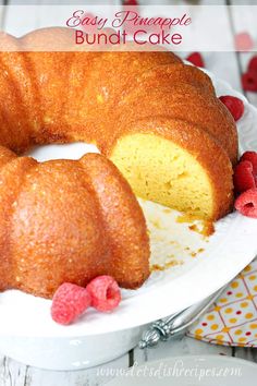 a bundt cake on a plate with raspberries