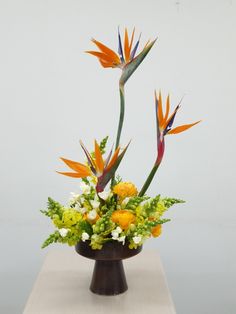 an arrangement of flowers in a vase on a table