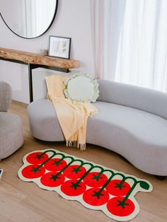 a living room with a couch, mirror and rug