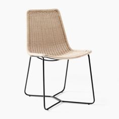 a chair that is made out of wicker and black metal legs, on a white background