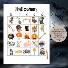 a halloween bingo game with pumpkins, bats and witches on it's board