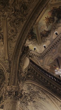 an ornate ceiling with paintings and chandeliers