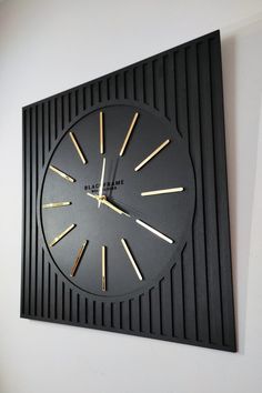 a black and gold clock on the wall