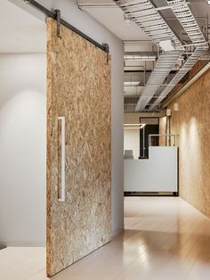 an empty room with wood paneling and white walls