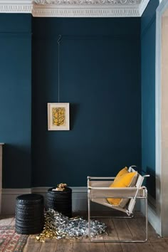 a living room with blue walls and wooden floors