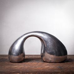 a metal object sitting on top of a wooden table