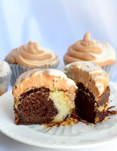 a chocolate cupcake cut in half on a plate