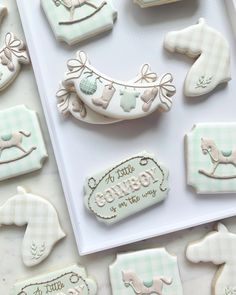 some cookies that are sitting on a table next to each other and decorated with baby items