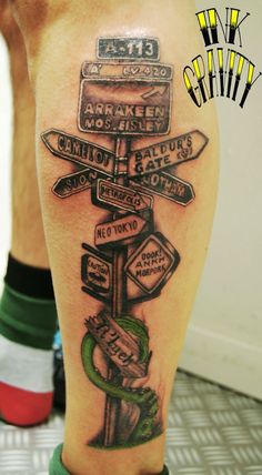 a man with a tattoo on his leg that has many signs and names on it