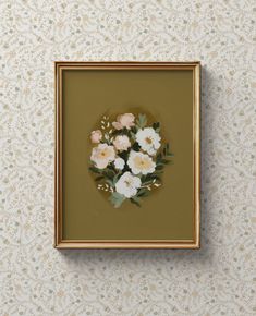 there is a painting on the wall with flowers painted on it and gold frame in front