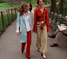 two women walking down a path in the park