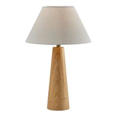 a wooden table lamp with a white shade