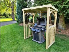 an outdoor bbq and grill in the grass