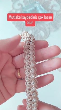 a hand holding a crocheted ring in it's left hand with the words muttaka kadydenizz gok lazan ollu