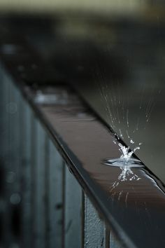 a broken glass on top of a metal rail