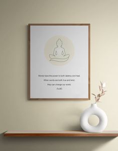 a white vase sitting on top of a wooden shelf next to a framed print with a buddha quote