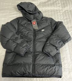 Nike Windrunner PrimaLoft Storm-Fit Puffer Jacket  Size: Men's XXL Color: Black DR9605-010 MSRP: $200 Measurements: Chest (armpit to armpit) - 27 inches Length (top to bottom) - 30 inches Rock the iconic look of the Windrunner while you brave the cold in this toasty hooded jacket. It takes the classic puffer look and backs it up with the insulating power of PrimaLoft® Thermoplume insulation. Nike Storm-FIT technology resists elements like wind and water to help keep you comfortable in harsh weather conditions. A relaxed fit gives you some room to layer up underneath for those extra chilly days. More Benefits Style: Standard-fit Windrunner puffer jacket Materials: Water-repellent and windproof woven fabric Construction: Superwarm PrimaLoft insulation with smooth taffeta lining Storage: Zipp Nike Windrunner, Puffer Jacket Men, Fabric Construction, Weather Conditions, Puffer Jacket, Large Black, Water Repellent, Hooded Jacket, Vest Jacket