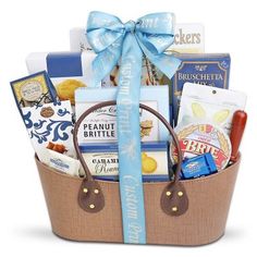 a basket filled with lots of different types of food and snacks on top of a white surface