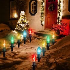 christmas lights are lit up in front of a house