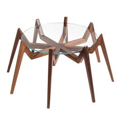 a glass table with wooden legs and a circular glass plate on the top that is shaped like an x