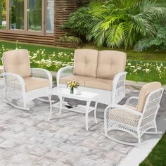 an outdoor patio furniture set with beige cushions