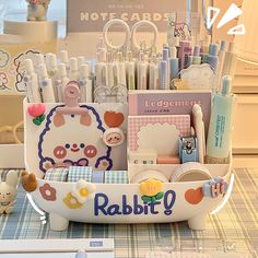 a basket filled with lots of different items on top of a table next to a stuffed animal