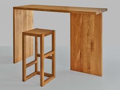 a wooden table with two stools next to it