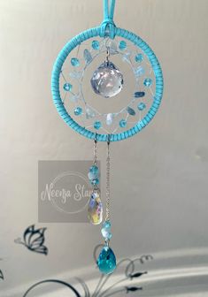 a blue and white dream catcher hanging from a ceiling