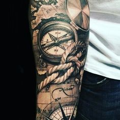 a man's arm with a compass, rope and other items on it that are all around him