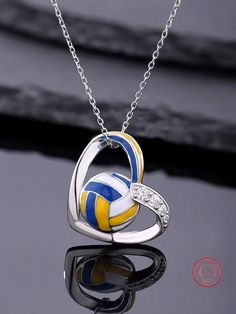 a volleyball ball is in the shape of a heart on a chain with diamond accents