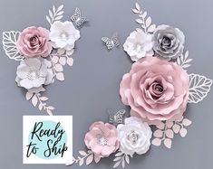 paper flowers and butterflies on a gray background