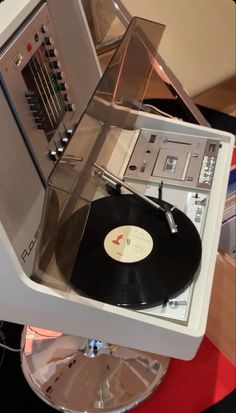 an old record player sitting on top of a turntable with vinyl records in it