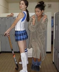 two young women standing next to each other in a locker room