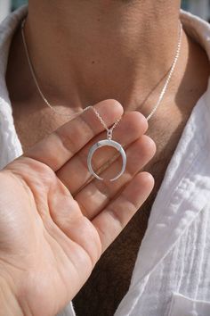 Embrace the magic of the moon with our Moon Ring Holder Necklace, a stunning blend of celestial beauty and practical design. This handcrafted piece not only adds a touch of enchantment to your jewelry collection but also keeps your precious rings safe and close. Premium Materials: Expertly crafted from high-quality 925 sterling silver over 14k gold plated or rhodium , ensuring durability and a radiant shine. Secure Moon Design: The moon-shaped pendant features a secure holder mechanism, perfect for keeping your rings safe and accessible. Celestial Charm: Inspired by the moon's serene beauty, this necklace adds a touch of cosmic elegance to any outfit. Thoughtful Gift: Ideal for weddings, anniversaries, birthdays, or any special occasion for the moon lover in your life. Ring Holder Pendant, Crescent Ring, Ring Holder Necklace, Precious Rings, Necklace Mens, Moon Ring, Celestial Jewelry, Practical Design, Mens Ring