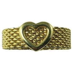 Tiffany & Co. 18 Karat Yellow Gold Somerset Heart Mesh Ring Size 5 This stunning heart mesh ring by Tiffany & Co. is crafted in meticulously detailed 18K yellow gold. Width: 6 mm. Ring Size: 5 Weight: 7.0 gr./ 4.5 dwt. Hallmark: T&CO 750 Very good condition, professionally polished. Will come packaged in a gift box or pouch (when possible) and will be shipped U.S. Priority Mail Insured. DV073123/17KC600 College Rings, Open Heart Ring, Gold Heart Bracelet, Tiffany Diamond, Contemporary Engagement Rings, Platinum Engagement Rings, Tiffany And Co, Gold Bracelet Chain, Heart Bracelet