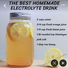 the best homemade electrolyte drink is in a mason jar with lemon wedges