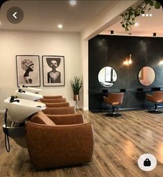 a salon with chairs, mirrors and pictures on the wall