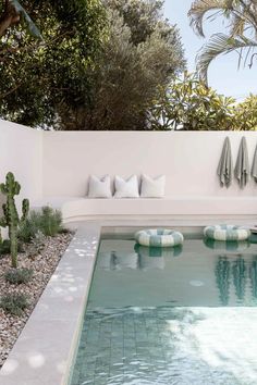 a pool with some pillows on the side