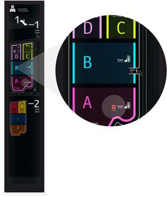 the back side of a black and white video game controller with colorful letters on it