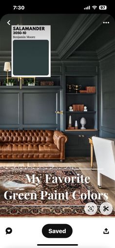 an image of a living room with green paint colors on the walls and leather couches