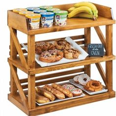 an assortment of donuts and other pastries on a wooden shelf