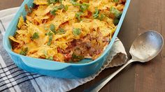 a casserole dish with meat, cheese and vegetables in it on a table