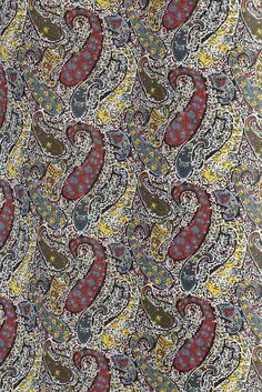 an intricately designed paisley print fabric with red, yellow and blue flowers on it