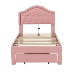 a pink bed frame with buttons on the headboard and foot board, against a white background