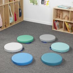 children's playroom with various colored stools and storage bins on the floor