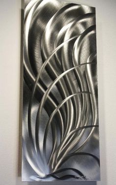 an abstract metal art piece hanging on the wall