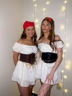 two women dressed in costumes posing for the camera