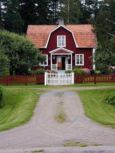 a red house with a white picket fence